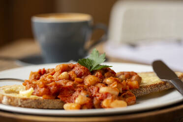 Close up of home made baked beans on sourdough bread in a cafe. - MINF14638