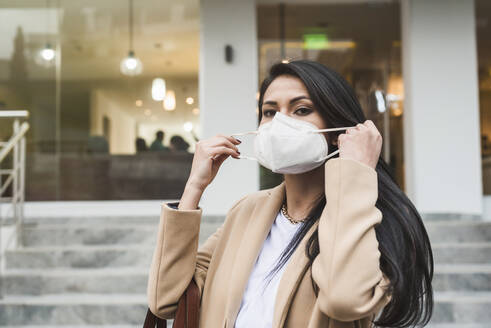 Woman with protective mask in city - DSIF00024