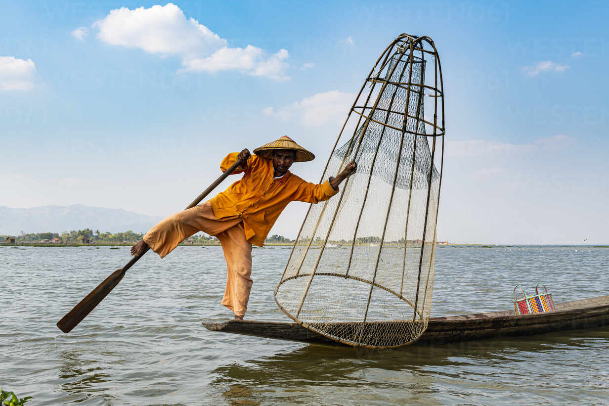 Fisherman at Inle Lake with traditional Intha conical net, fishing