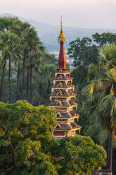 Top of a pagoda rises out of the forest, Kyaikthanian paya, Mawlamyine, Mon state, Myanmar (Burma), Asia - RHPLF15555