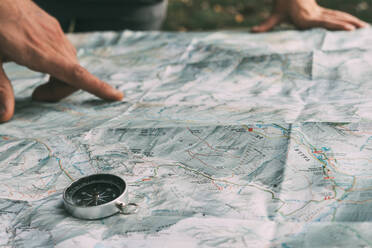 Planung der Route auf einer Karte und einem Kompass - CAVF86902