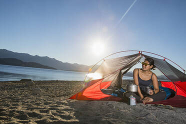 Woman relaxing at camp at the Nahuel Huapi Lake in Patagonia - CAVF86993