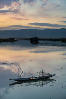 Wolken und traditionelles Ruderboot, das sich bei Sonnenuntergang im Wasser spiegelt, Inle-See, Shan-Staat, Myanmar (Burma), Asien - RHPLF15951