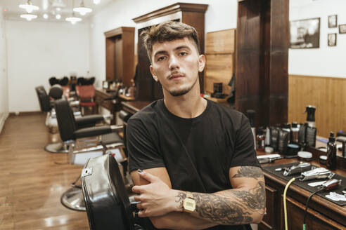 Trendy hairdresser standing arms crossed at salon - XLGF00385