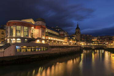 Embankment of modern city with bright lights of aged buildings under dark twilight sky reflecting in river water - ADSF01194