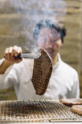 Chef cooking in restaurant preparing beef roast - ADSF01238