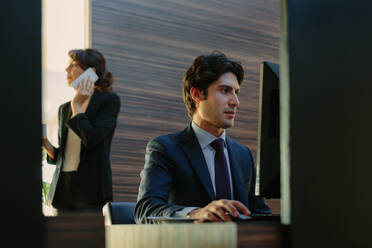 Businessman and businesswoman working in business centre in hotel - CUF55912