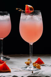 Cocktail grapefruit. Alcoholic beverage with tropical fruits lavender and ice flowers - ADSF01311