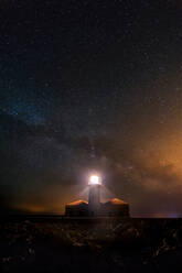 Lighthouse shining in the night of stars. Cavalleria, Menorca, Spain - ADSF01385