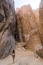 Young lady walking in the weshwash valley, south sinai mountain desert - CAVF87147