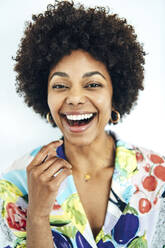 Cheerful mid adult woman with afro hairstyle against white background - EHF00577