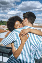 Romantic mid adult couple embracing during sunny day - EHF00611