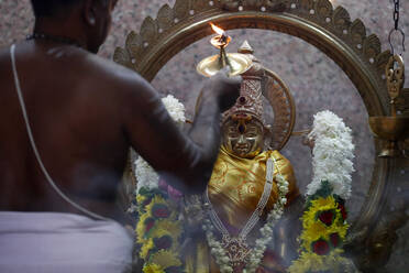 Hindu priest doing puja worship, Durga, Hindu Goddess of War, Sri Mahamariamman Hindu Temple, Kuala Lumpur. Malaysia, Southeast Asia, Asia - RHPLF16091