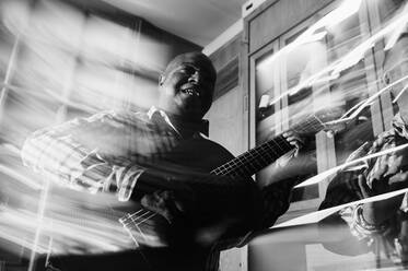 Musician playing guitar in in the night club - ADSF01393