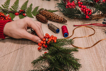 Hände auf Holztisch mit Weihnachtsdekoration - ADSF01594