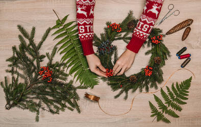 Hands on wooden table with christmas decoration - ADSF01598