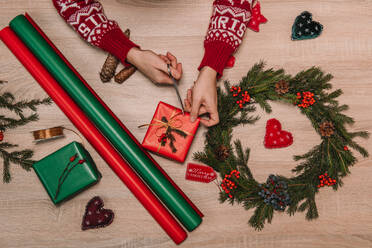 Crop woman tying a ribbon of a christmas gift surrender of decoration - ADSF01600