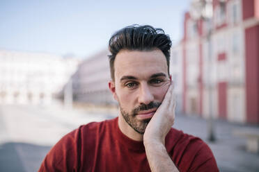 Close-up of bored man with hand on face - GRCF00275