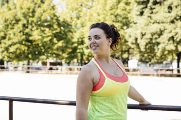 Sporty young woman relaxing in public park - CAVF87263