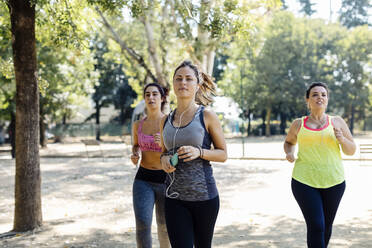 Young active female friends running in park - CAVF87268