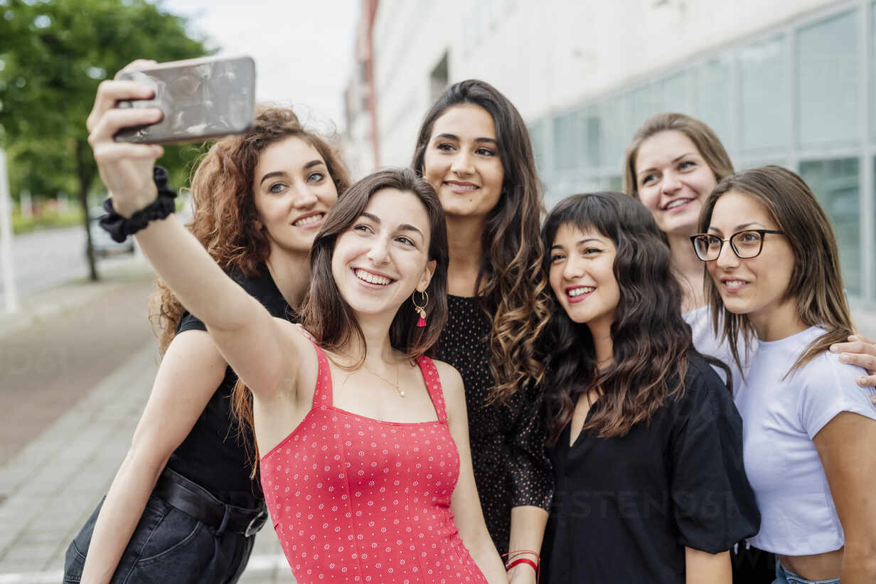 Two happy young women taking a selfie with a smart phone - a Royalty Free  Stock Photo from Photocase