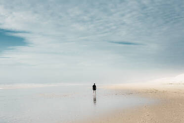 Human on sand beach near water and cloudy sky - ADSF01992