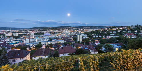 Germany, Baden-Wurttemberg, Stuttgart, Moon glowing over houses in Relenberg district - WDF06130