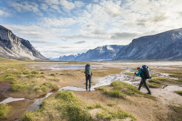 Backpackers hiking through Akshayak Pass, Baffin Island, Canada. - CAVF87341