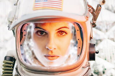 Beautiful woman poses looking at camera dressed as an astronaut. - ADSF02154