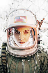 Beautiful woman poses looking at camera dressed as an astronaut. - ADSF02155