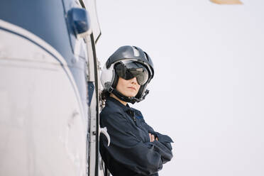 Pilot girl poses with her helicopter and helmet - ADSF02177