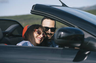 Man and woman travel in convertible car. - ADSF02181