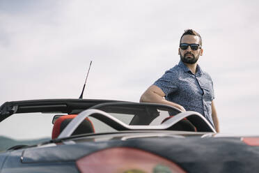 Attractive man posing in convertible car. - ADSF02183