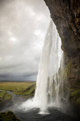 From below view of powerful?incredible cascade with stone slope and stream in Iceland - ADSF02214