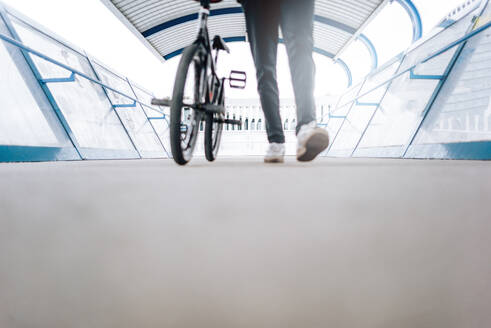 Defocused young man poses with BMX bicycle. - ADSF02419