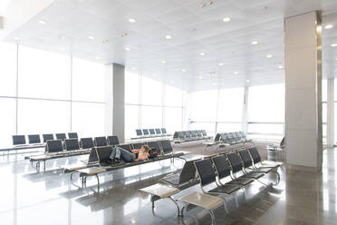 Tourist woman lying and resting on bench in terminal in Thailand. - ADSF02474