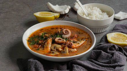 Soup of octopus and shrimps near rice and lemon - ADSF03048