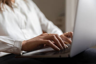 Young girl working with her laptop at home - ADSF03180