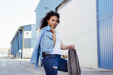 Teenager with skateboard on street - ADSF03474