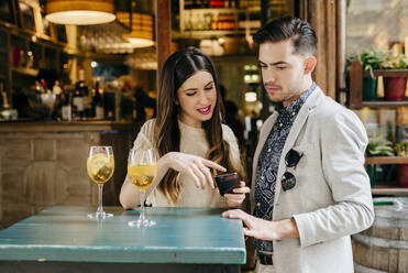 Couple sitting at table in outside cafe - ADSF03508