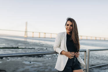 Young woman standing on waterfront - DCRF00518