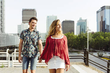 Couple holding hands and walking on street - ADSF03602