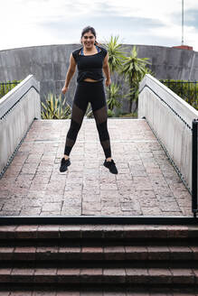 Young woman during workout on bridge - JMPF00233