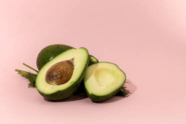Fresh avocados on pink background. Isolated - ADSF03943
