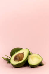 Fresh avocados on pink background. Isolated - ADSF03944