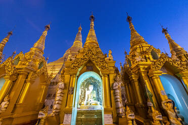 Myanmar, Yangon, Golden spires and Buddha statue at Shwedagon pagoda - RUNF03980