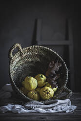 Basket with autumn leaves and exotic fruits - ADSF04456