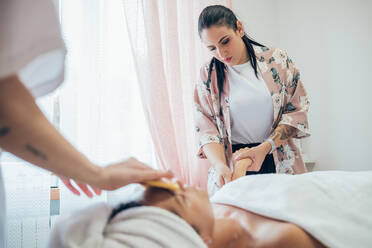 Woman getting a facial treatment in a beauty salon. - CUF56183