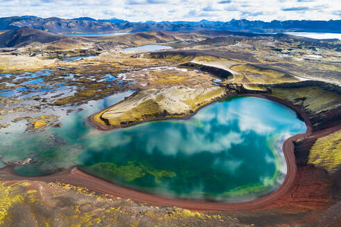 Aerial view of crater lakes with reflection of the sky and mountains in the colorful Veidivotn area in the highlands of Iceland - AAEF09204