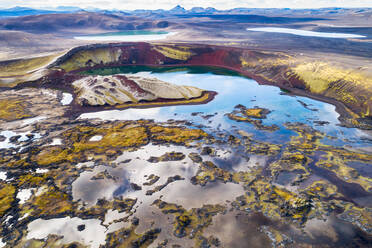 Aerial view of crater lakes with reflection of the sky and mountains in the colorful Veidivotn area in the highlands of Iceland - AAEF09205